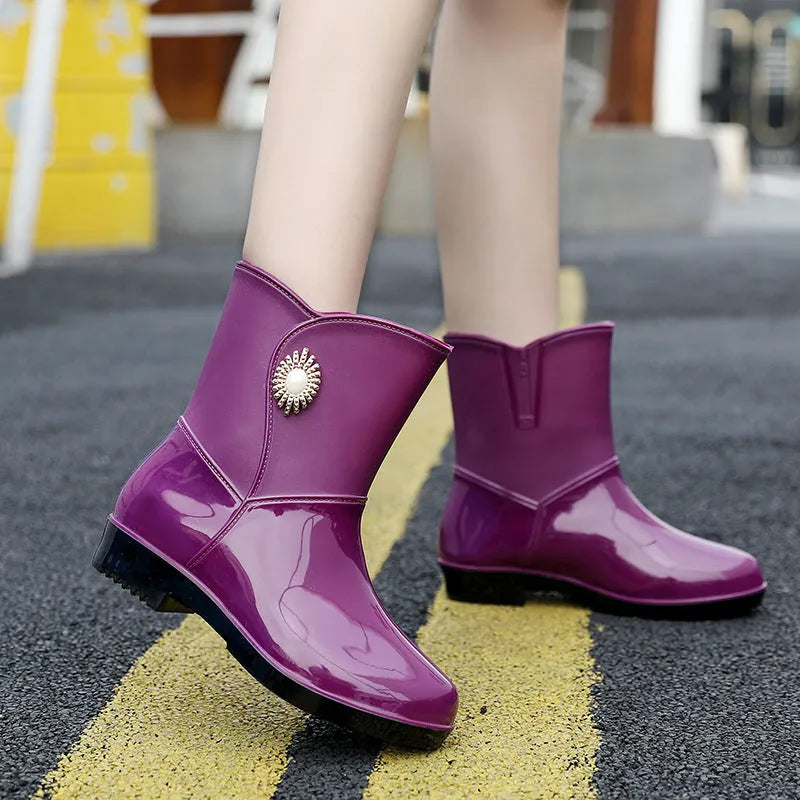 Women's mid-length PVC rain boots in purple, black, or beige with non-slip sole