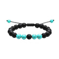 A pair of geometric matte black agate bead bracelets for couples on a neutral background.