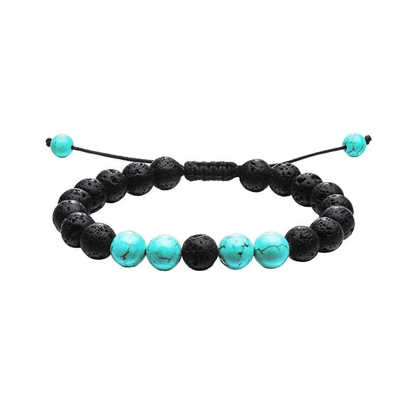A pair of geometric matte black agate bead bracelets for couples on a neutral background.