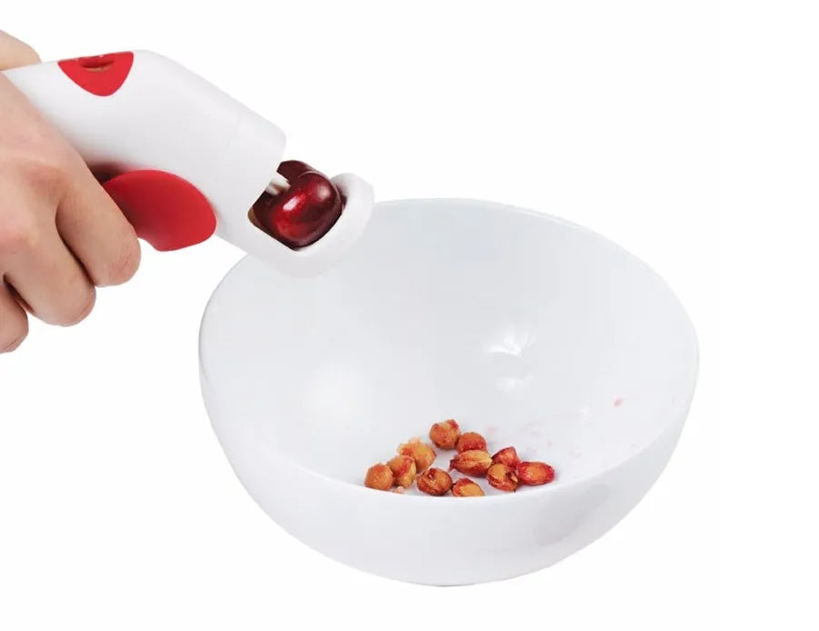 Cherry and olive pitting tool with red silicone handles and stainless steel mechanism