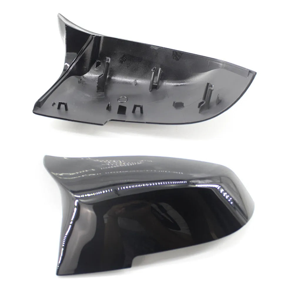Pair of dark bright black BMW horn-style rear-view mirror replacement shells.