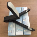 Black foldable aluminium tablet holder showing adjustable stand in open and closed positions on a desk.