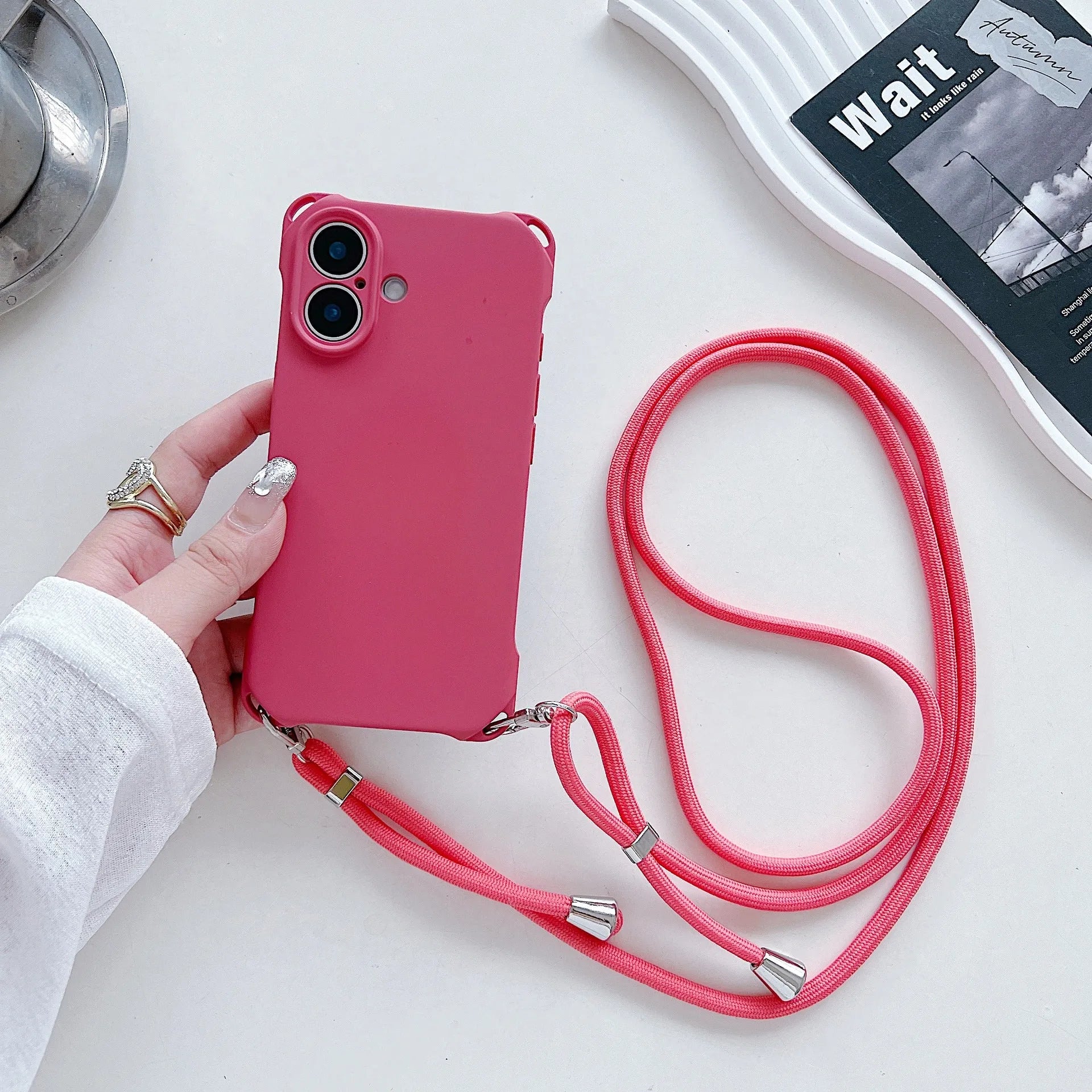 Four-corner cross lanyard liquid silicone phone case for Apple iPhone 16 in antique white with matching lanyard