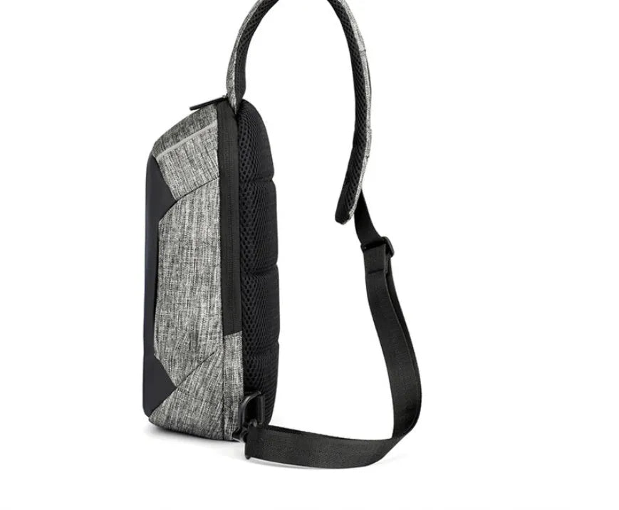 Small square dark blue Oxford cloth chest bag with a single strap and zipper, shown worn across the chest.