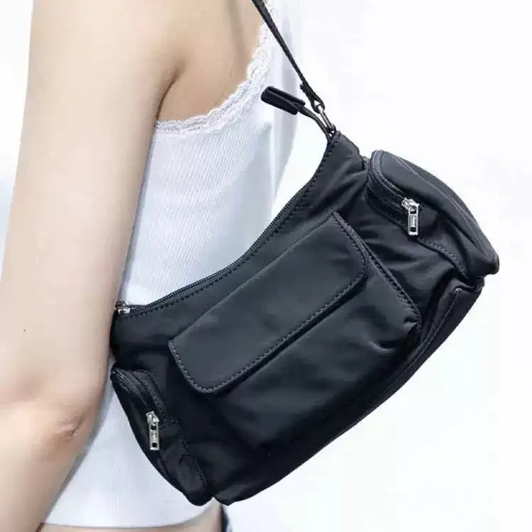 Black lightweight PU women's shoulder bag with two front pockets showing side stitching detail