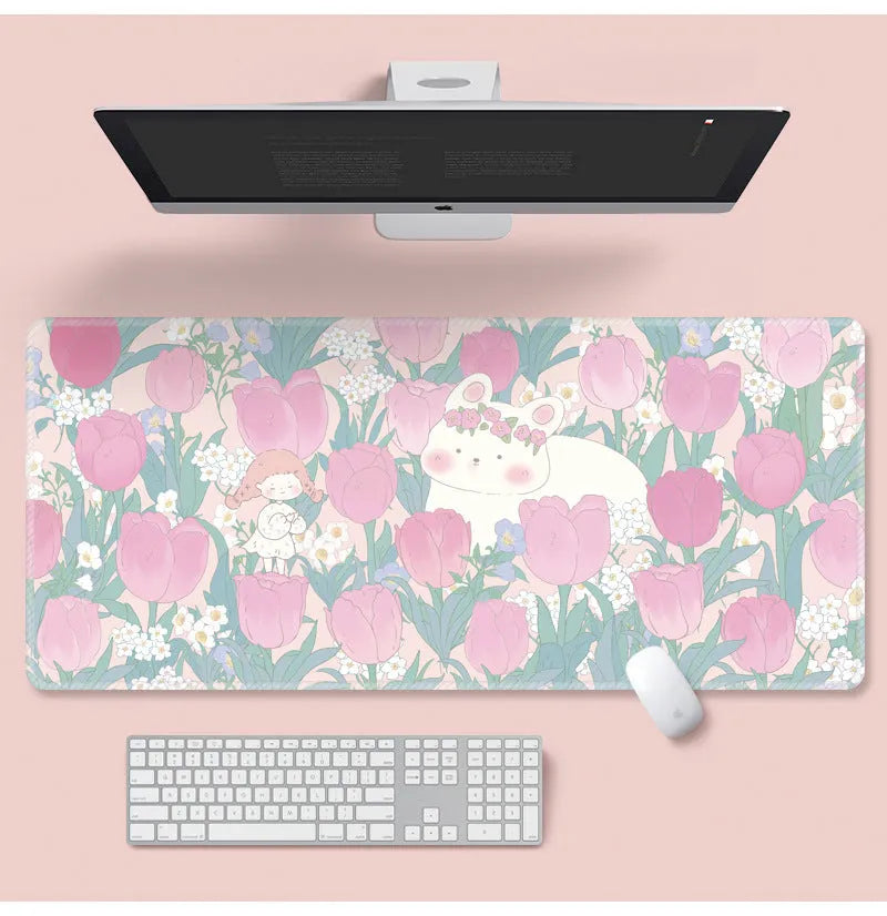 Large floral pattern mouse pad on a desk, showing non-slip rubber base and thin cloth surface.