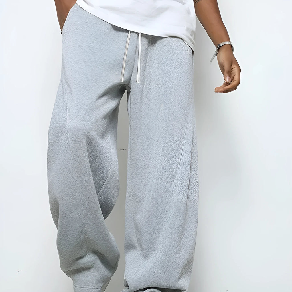 Men's straight-leg casual trousers in polyester with an elasticated waist, shown in black, grey and light grey.