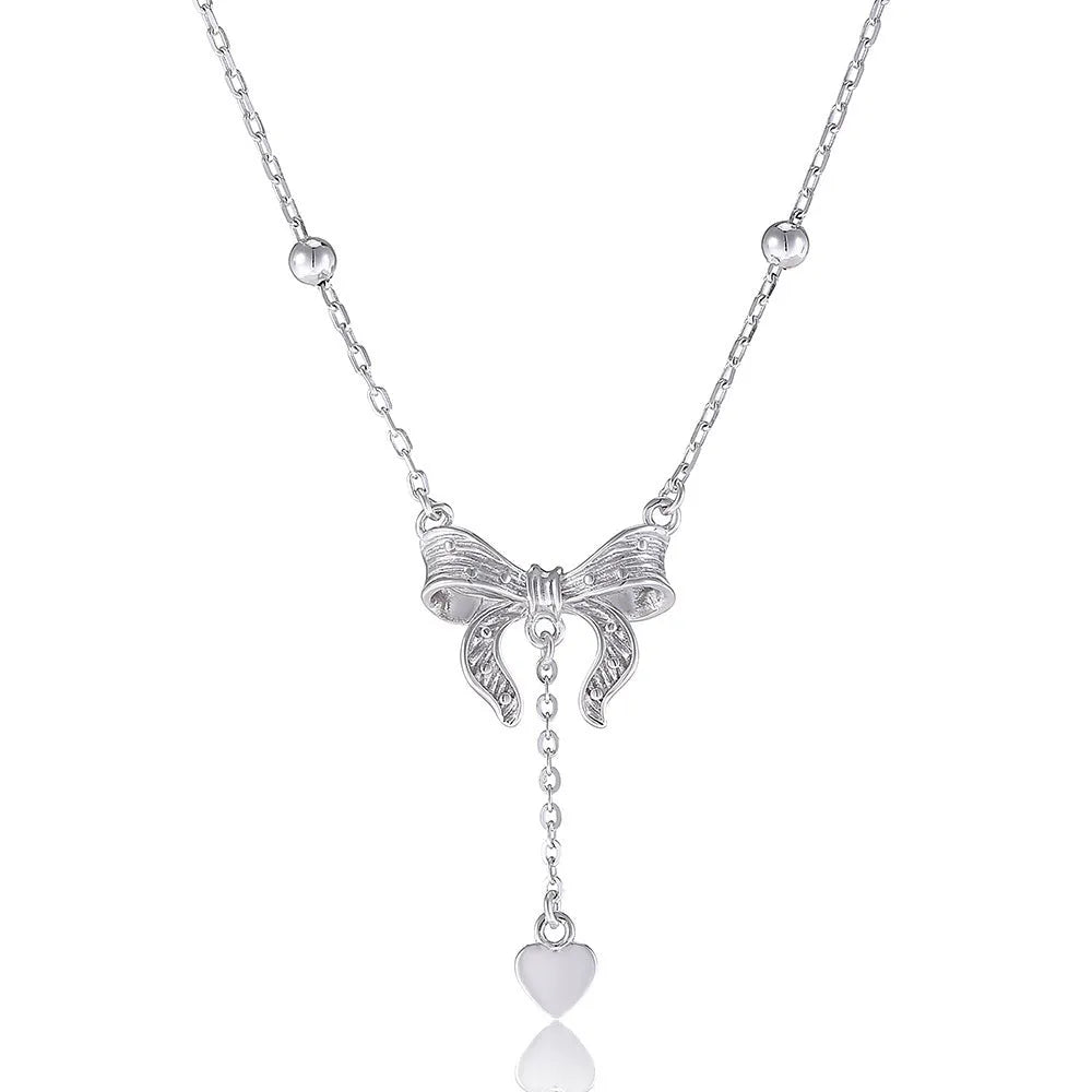 Close-up of a silver heart pendant necklace with butterfly detail on a 40-45cm O-ring chain.