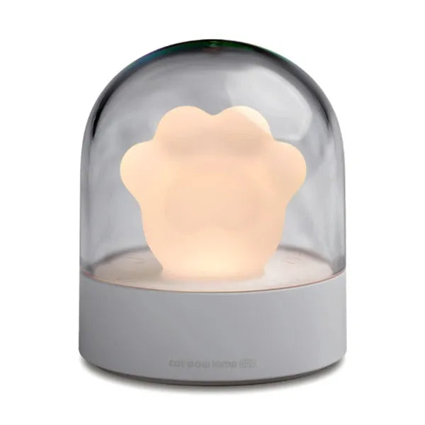 Grey cat paw shaped USB night light with rotating soft light and music box function on wooden desk
