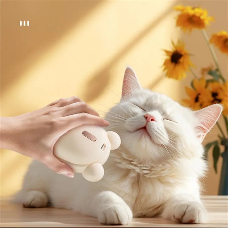 Pink and yellow rechargeable pet grooming brush with spray bottle, soft rubber teeth, and a removable silicone comb.