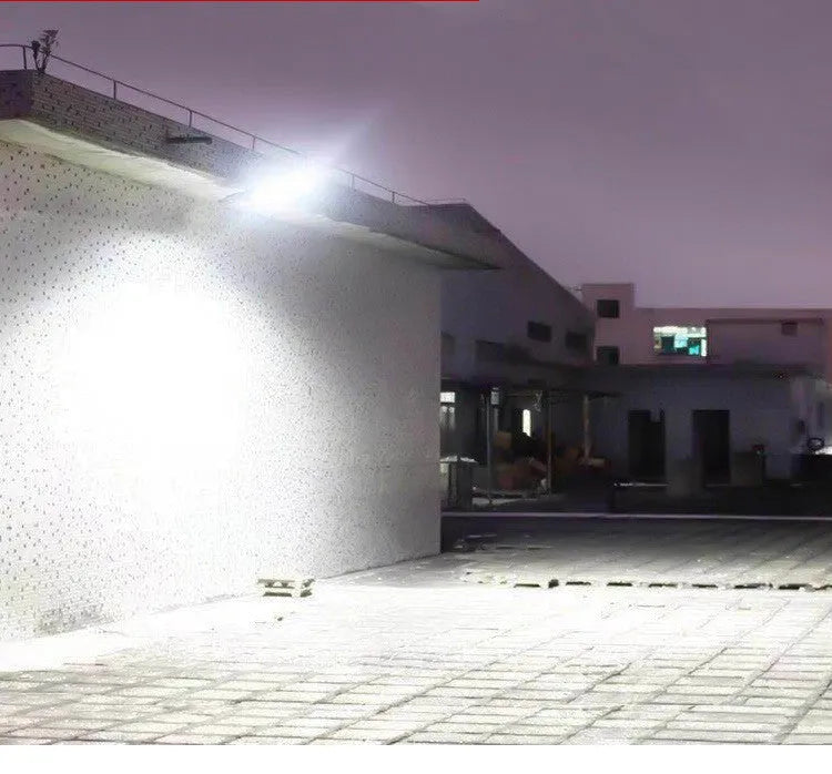 Black solar-powered outdoor wall light with motion sensor for garden and driveway security.
