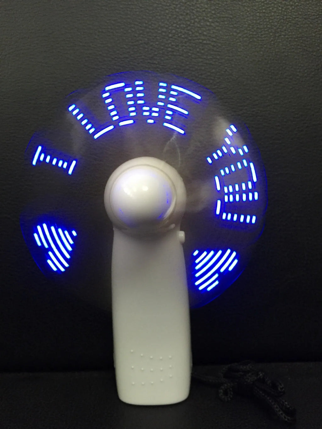 White handheld fan with LED lights displaying I Love You pattern in blue and red colours