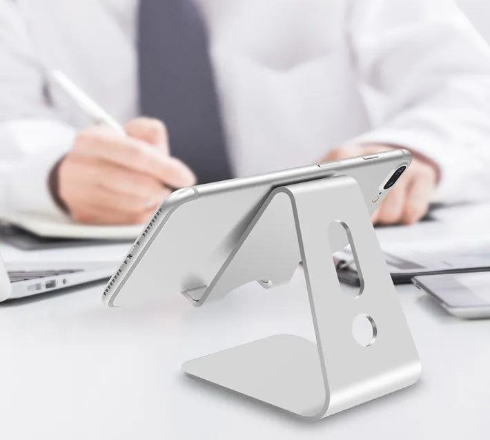 Aluminium universal stand holding a mobile phone and a tablet, shown in silver colour.