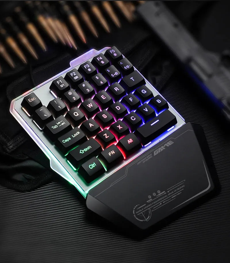Black robotic one-handed gaming keyboard with RGB backlighting and USB cable