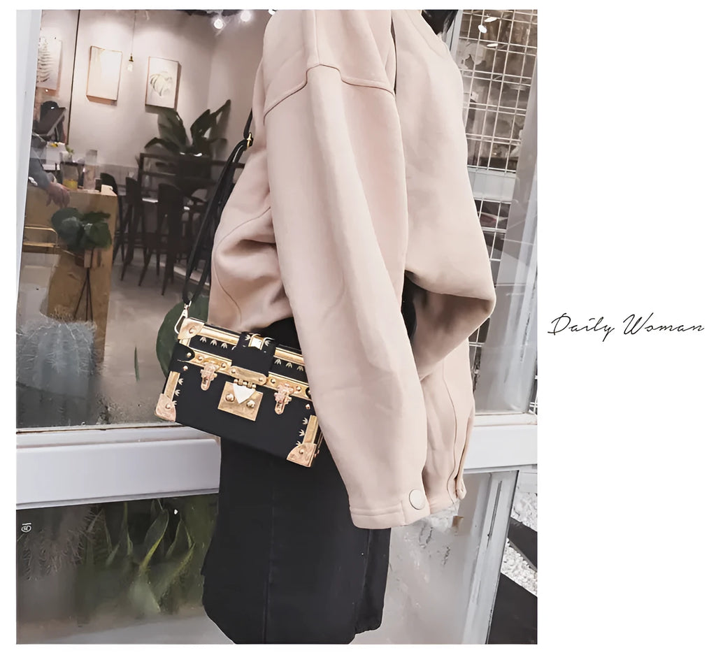Black or green women's hard-shell flap-over shoulder bag with single adjustable strap
