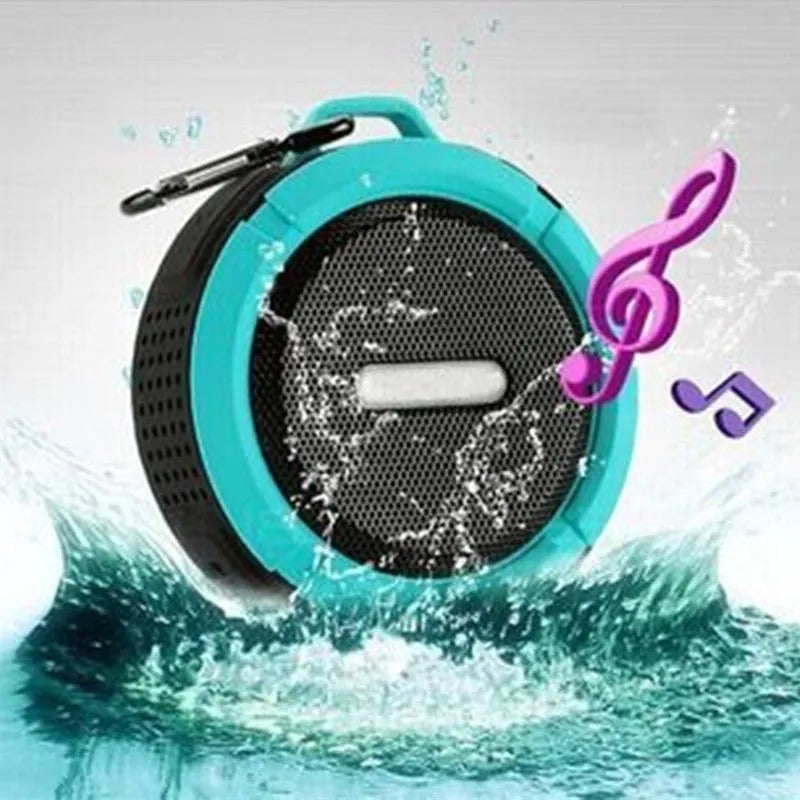 Portable waterproof Bluetooth speaker in blue with a mountaineering buckle clip for bags.