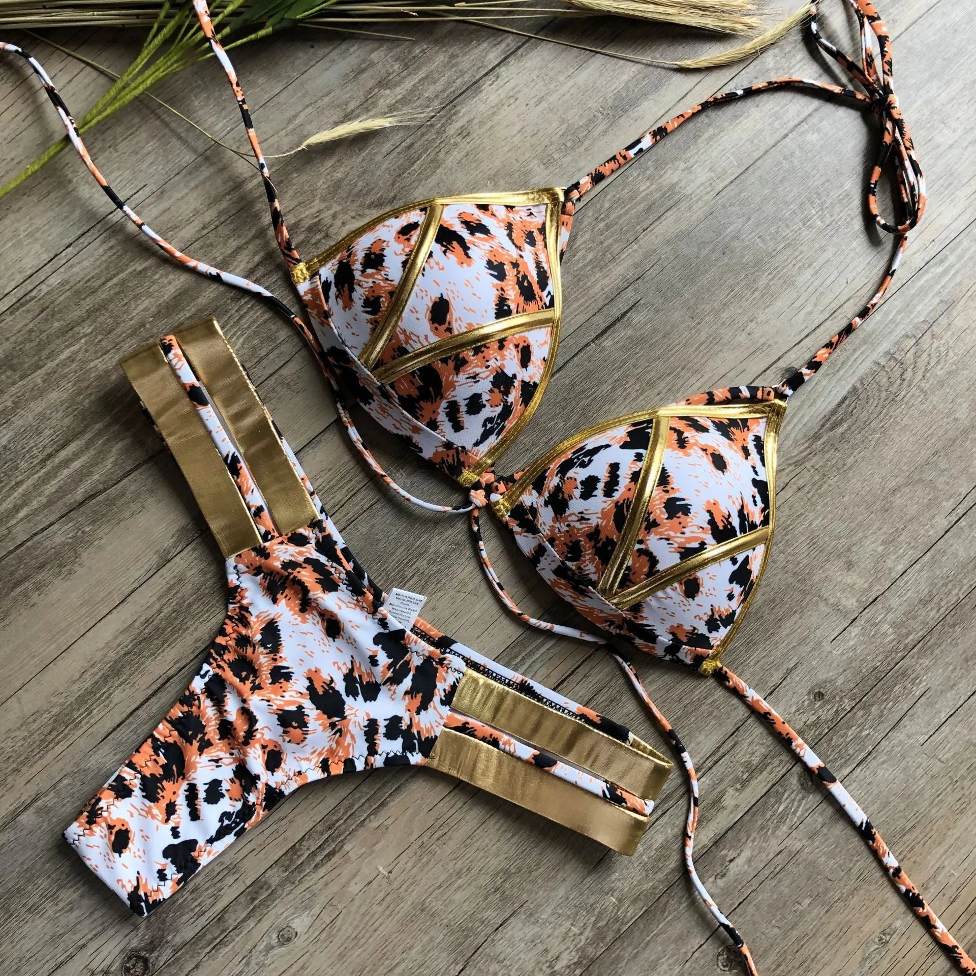 Women's bronzing bikini swimsuit with padded cups, shown in multiple colour and print options including leopard and snakeskin.