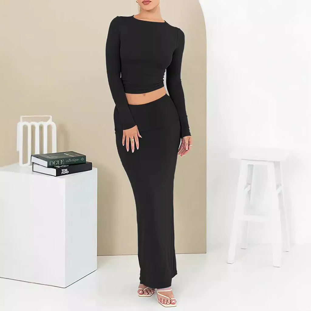 Women's black two-piece autumn suit featuring a crop top and long skirt in a slim fit.