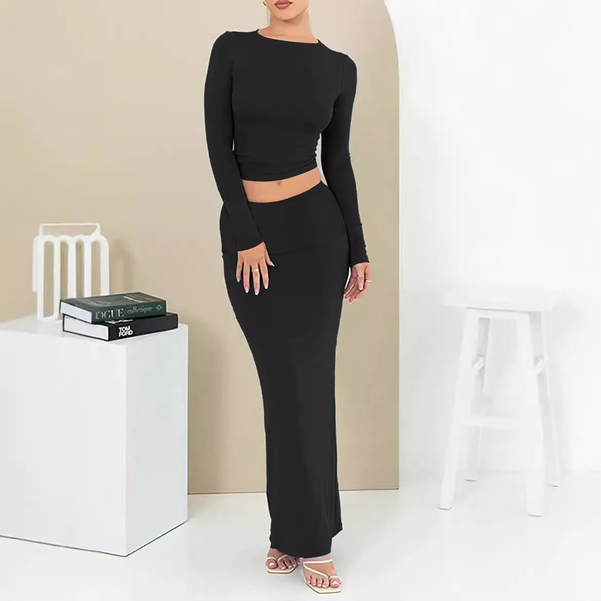 Women's black two-piece autumn suit featuring a crop top and long skirt in a slim fit.