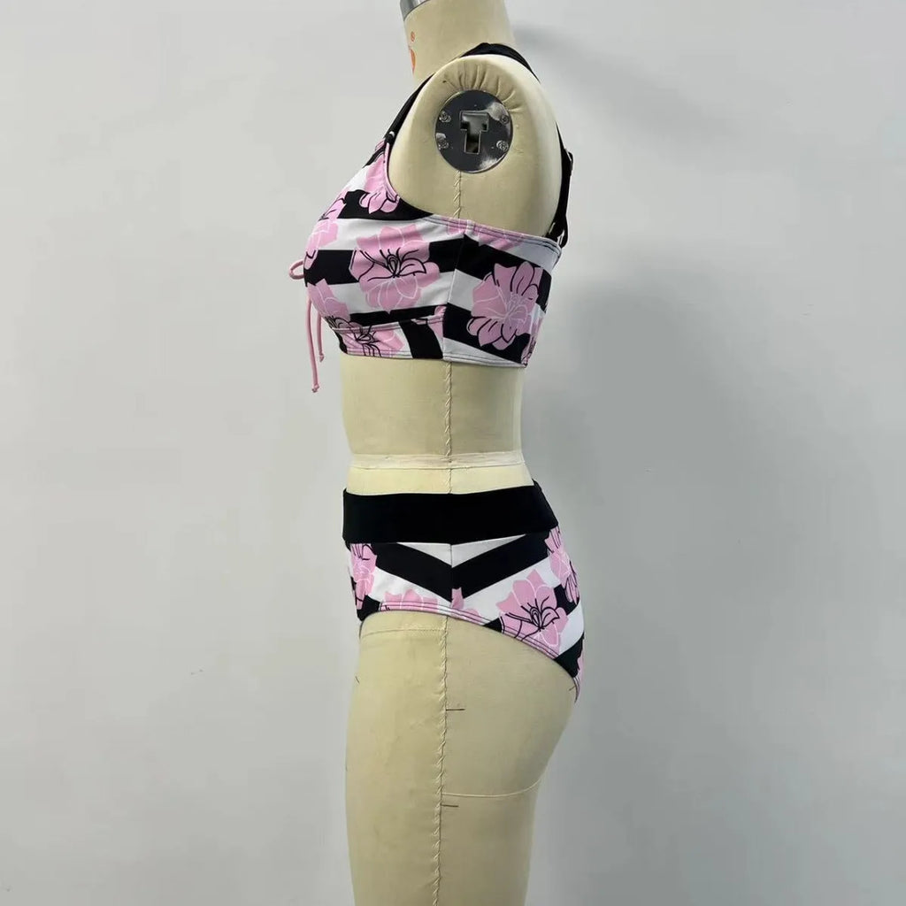 Black women's bikini with printed design, belly coverage and split leg style for swimming.