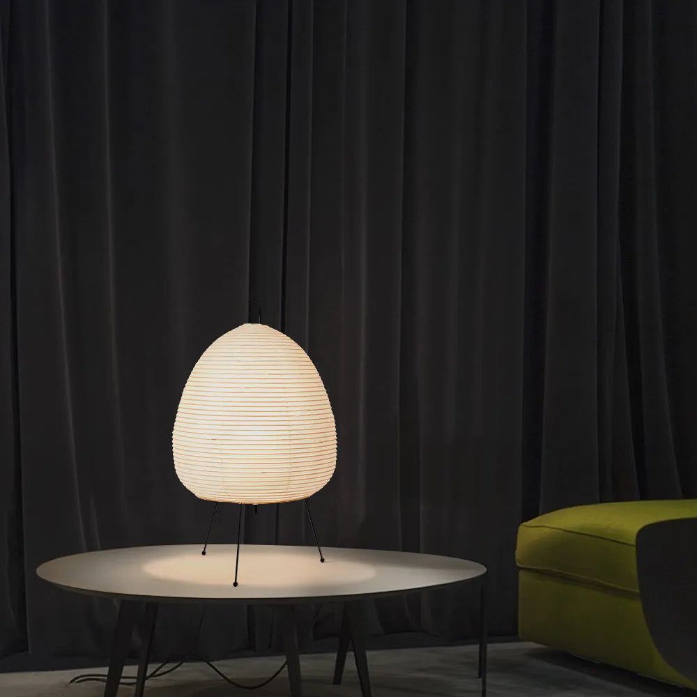 Japanese-style paper table lamp with handmade shade and aluminium base on wooden surface
