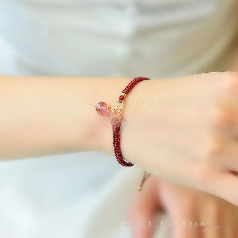 Women's natural strawberry quartz bracelet with detailed cherry charm and crystal beads.