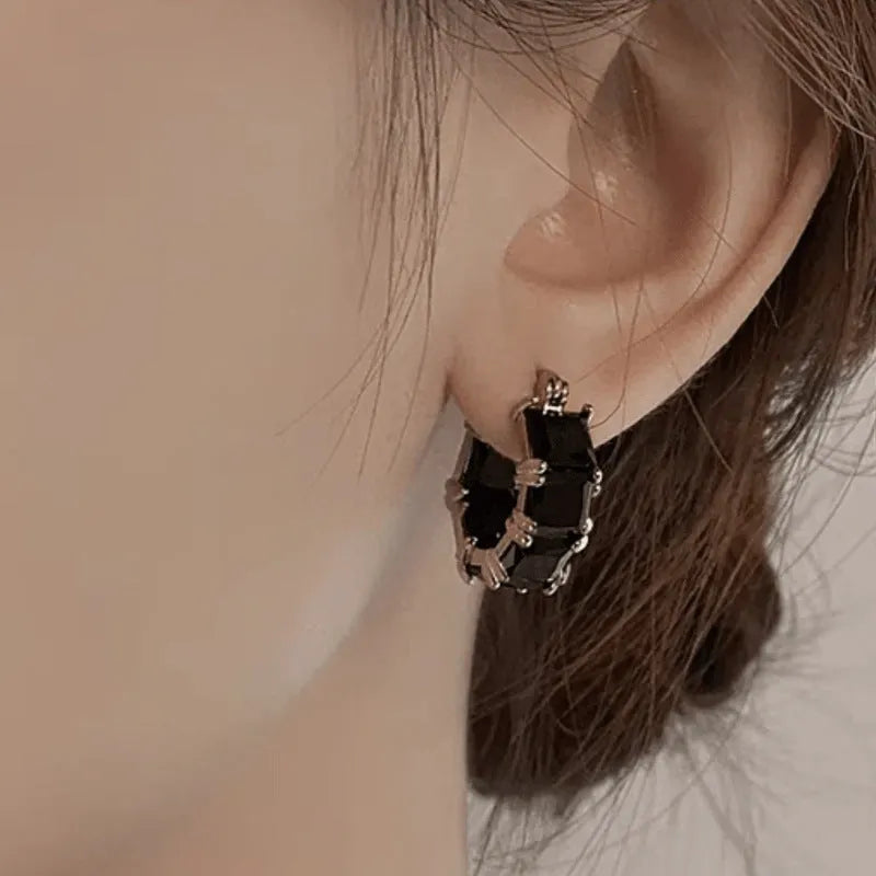 Gold electroplated copper earrings with geometric U-shape design and zircon crystals