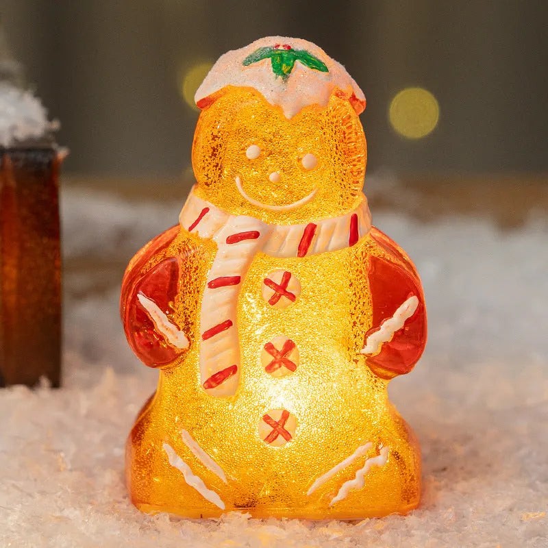 Glowing red-scarf gingerbread man Christmas ornament with modern design on a green tree branch.