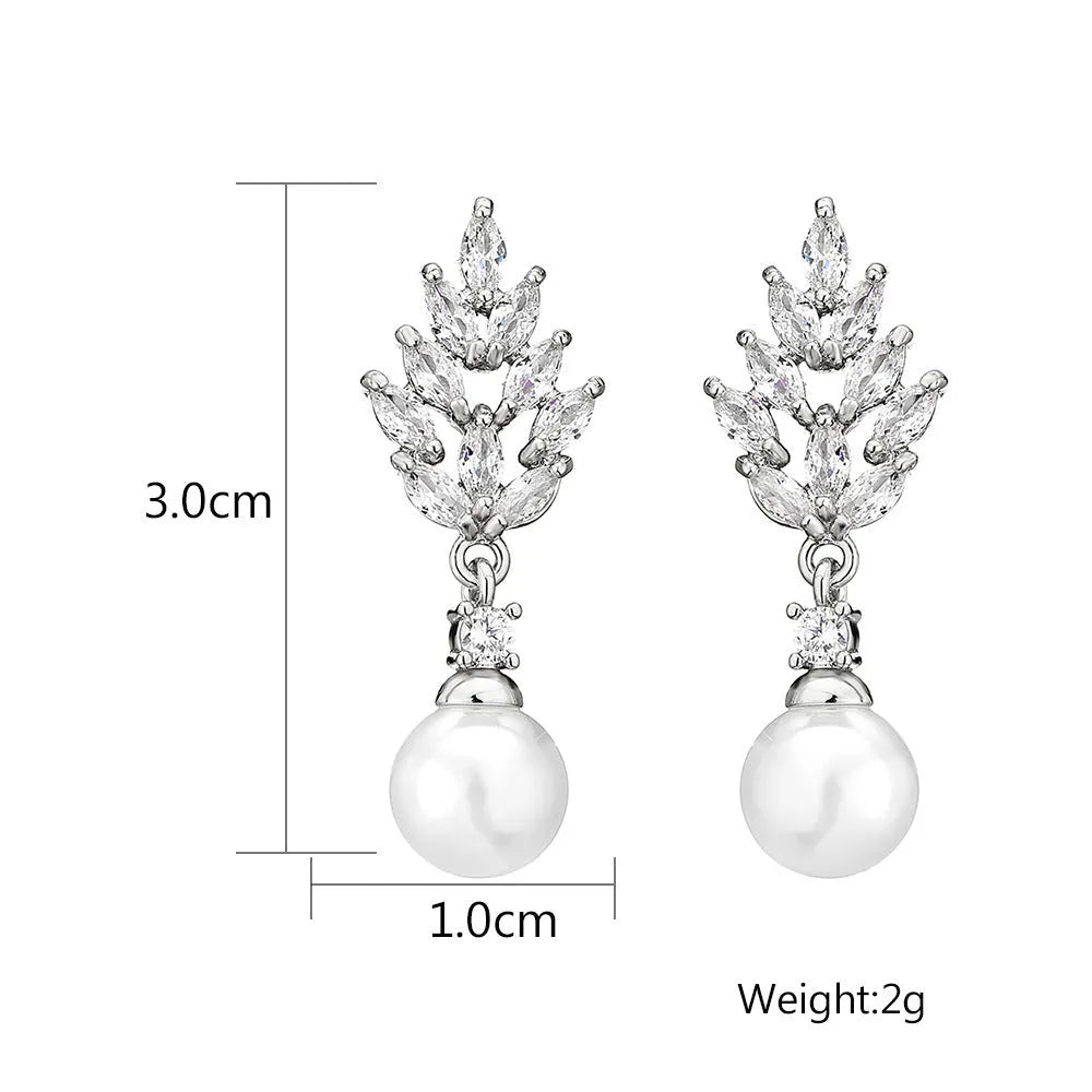 Geometric flower design pearl earrings with micro inlaid zircon stones in gold, platinum, or rose gold plated finishes.
