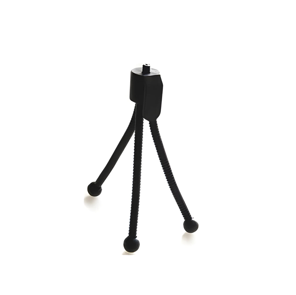 Small black iron mini tripod with ball head extended, next to an iPhone on a desk