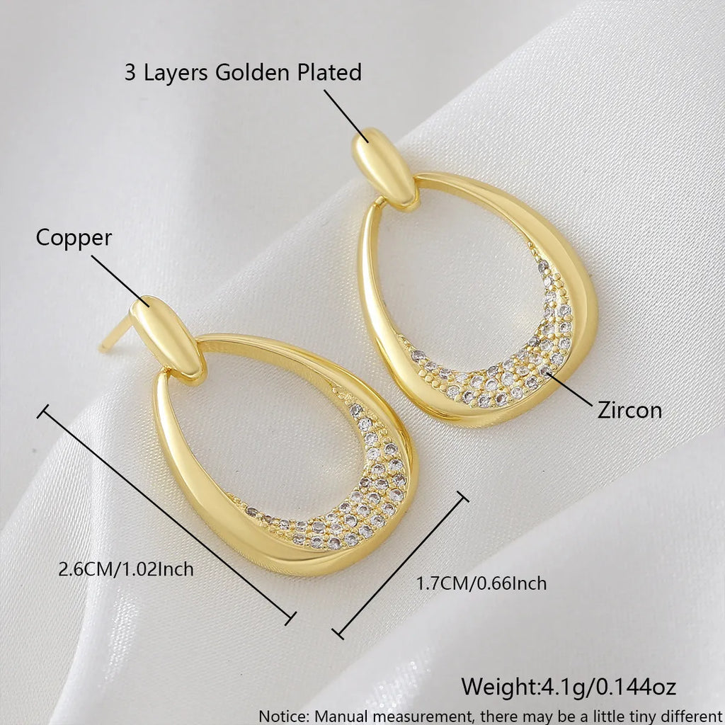 Yellow gold geometric drop earrings with zircon accents, measuring 2.6cm long by 1.7cm wide