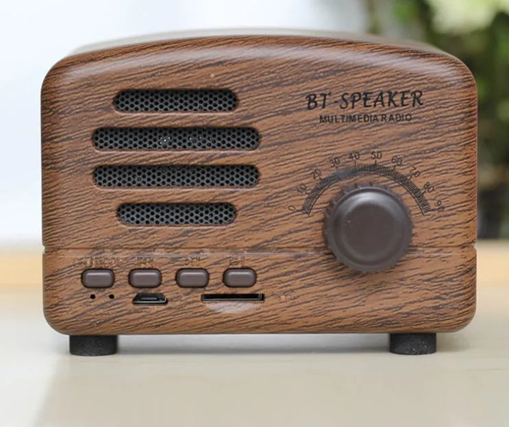 Vintage wood grain Bluetooth speaker in black, pink, and wood grain colours showing compact 93mm design