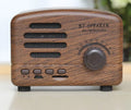 Vintage wood grain Bluetooth speaker in black, pink, and wood grain colours showing compact 93mm design