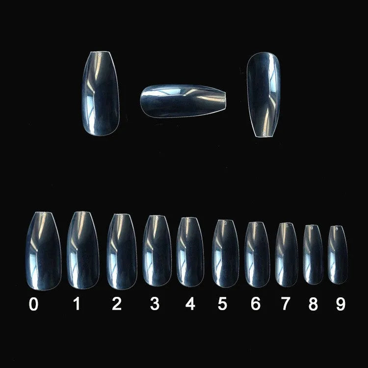 500 clear acrylic false nails in various sizes spread out on a table