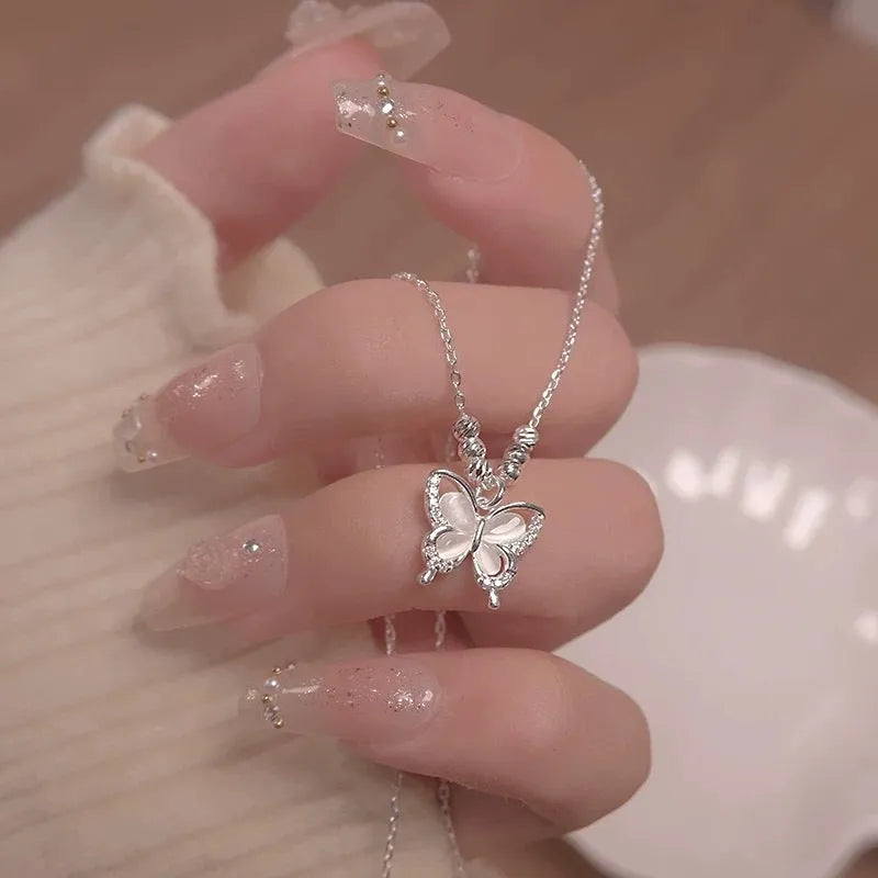Women's silver opal butterfly necklace on cross chain with square line design
