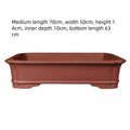 Large rectangular handmade purple clay bonsai flowerpot shown on a wooden surface.
