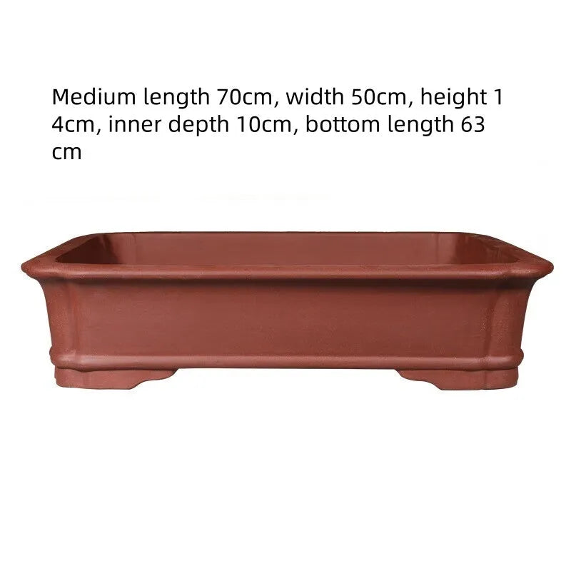 Large rectangular handmade purple clay bonsai flowerpot shown on a wooden surface.