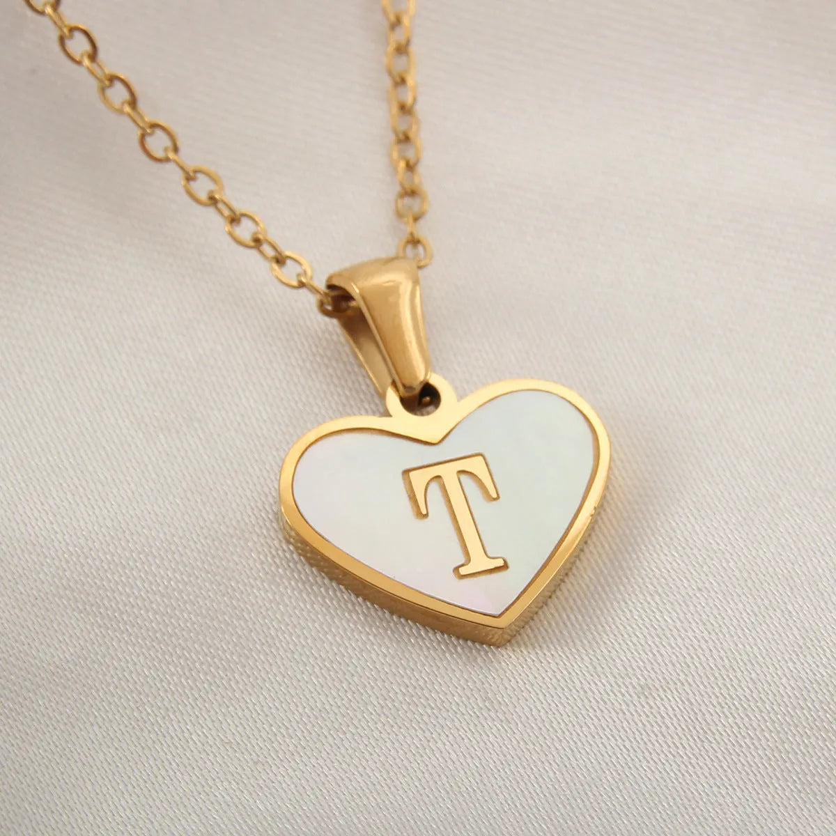 Gold heart necklace with white shell pendant and initial charm on 45cm adjustable chain