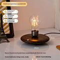 Iron art suspension bulb night lamp on a black wood grain base