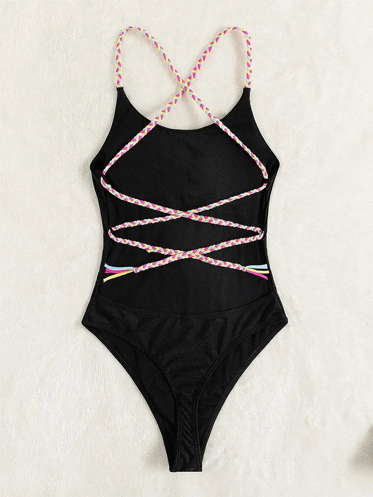 Black backless sleeveless one-piece swimsuit laid flat.