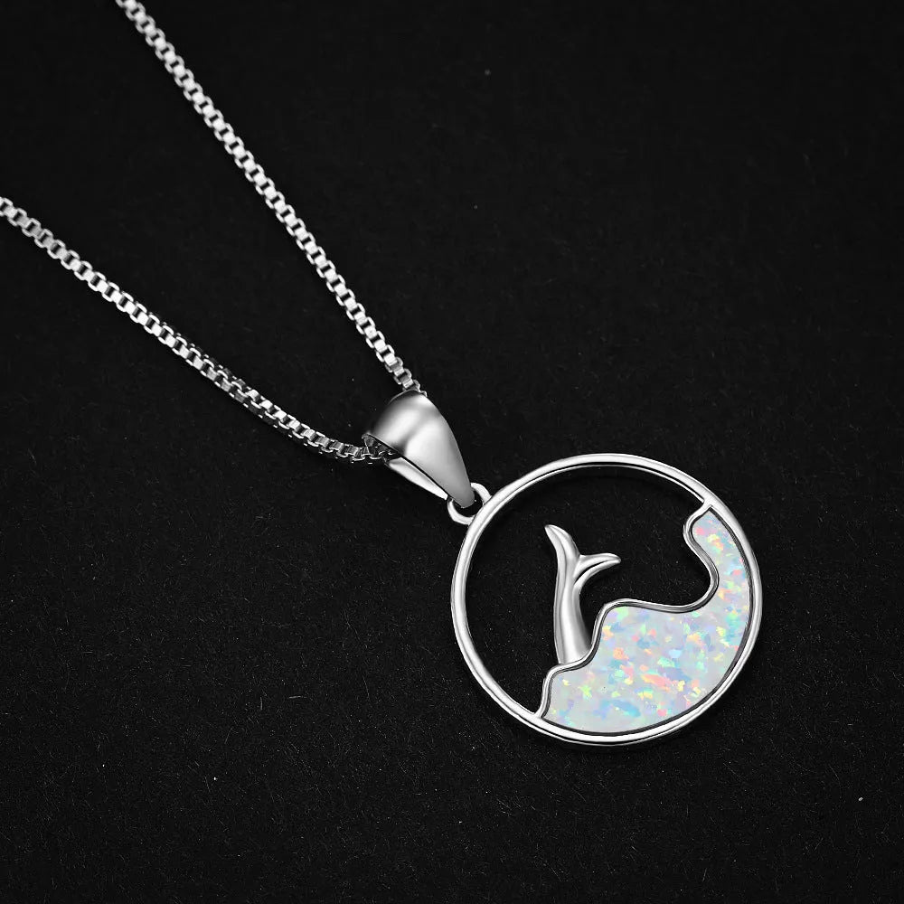 White gold electroplated copper necklace with geometric sea fishtail pendant in blue opal colour.