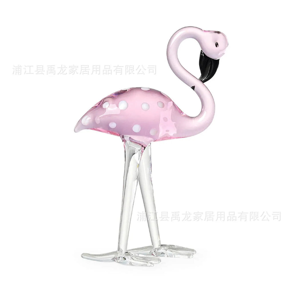 White crystal flamingo decorative ornaments with pink dots on a table