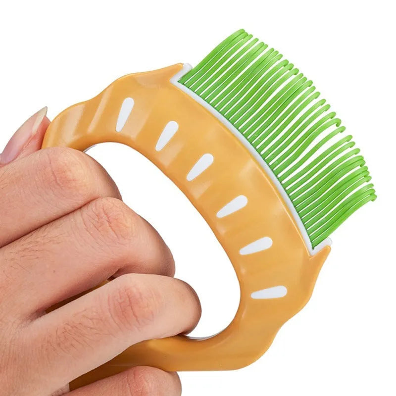 Green shell-shaped plastic pet grooming comb with bent wire bristles and an anti-slip handle.