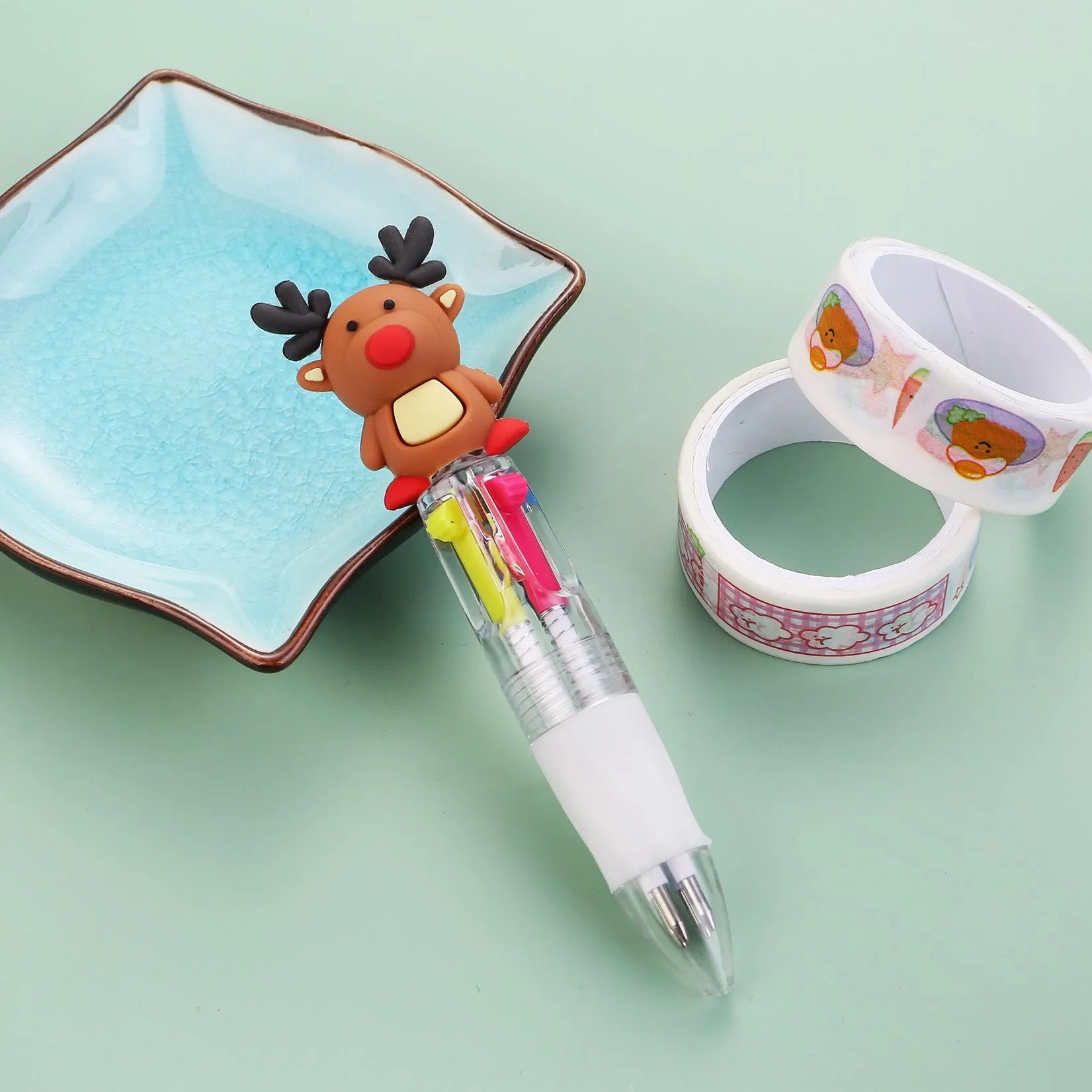 Christmas mini four-colour press-type ballpoint pen showing festive designs, 11cm long.
