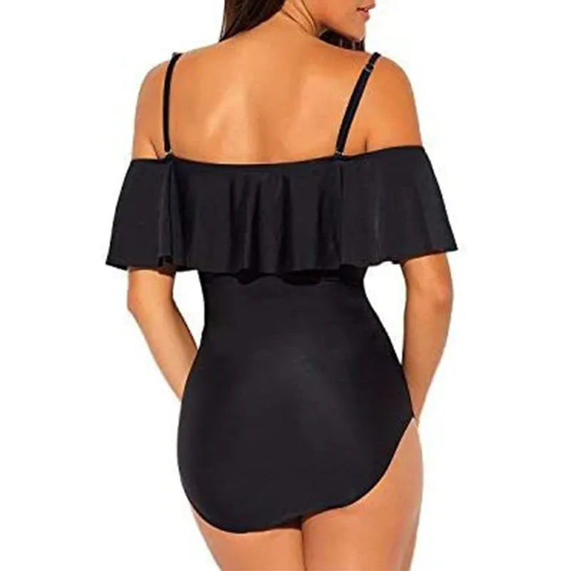 Black one-piece swimsuit with cut-out design and ruffled straps on the tube top.