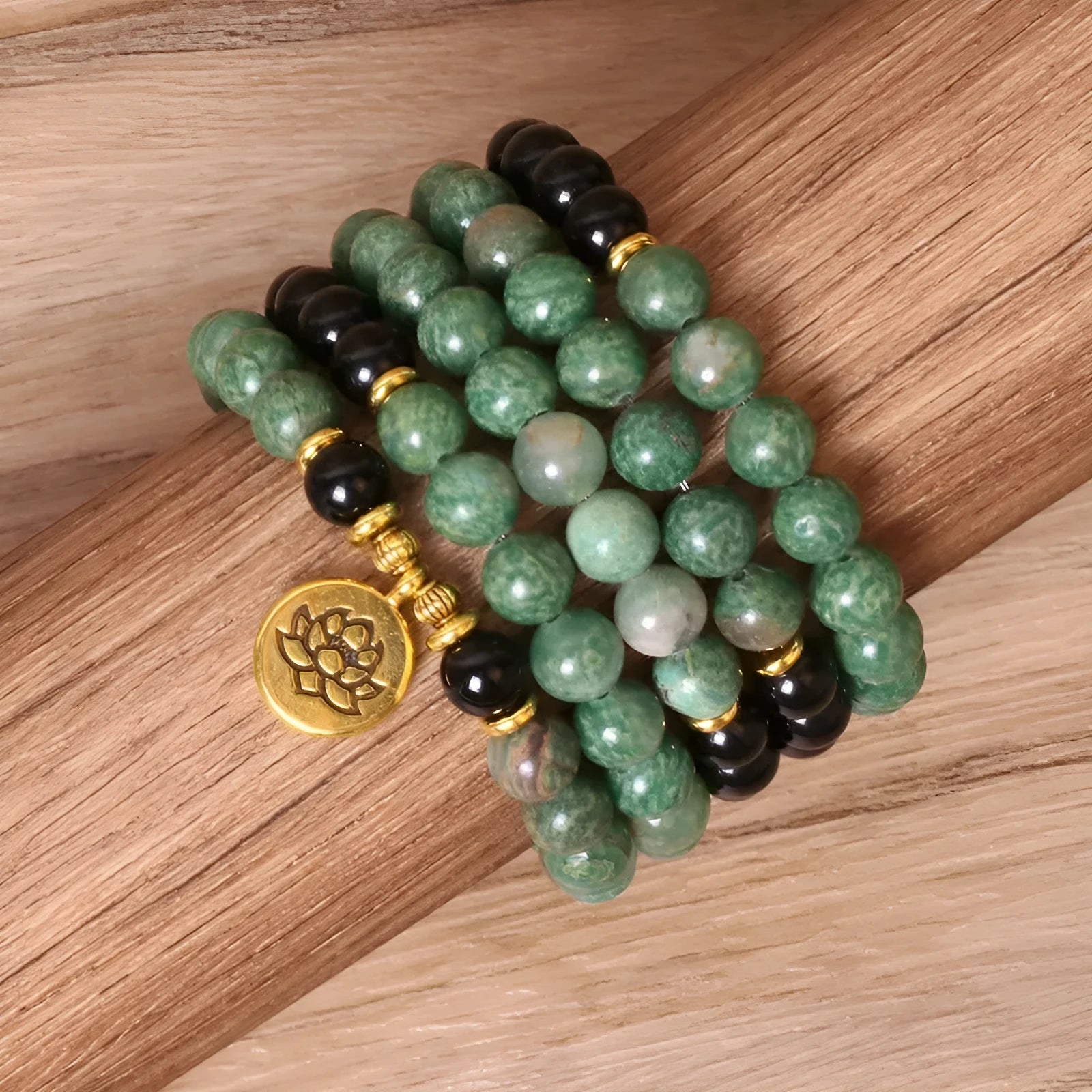 Green and black alloy elastic beaded bracelet on a wrist.