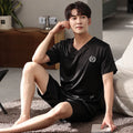 Men's ice silk short-sleeved pajama shirt and loose shorts set on a hanger.