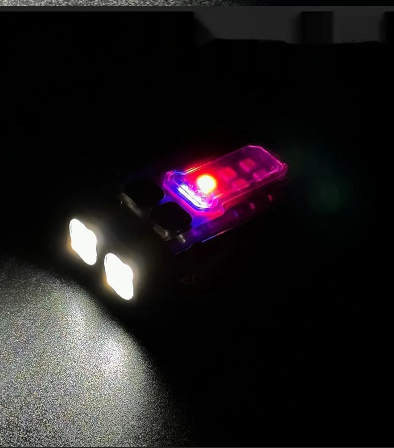 Mini black tactical warning flashlight with USB charging cable for backpack mounting.