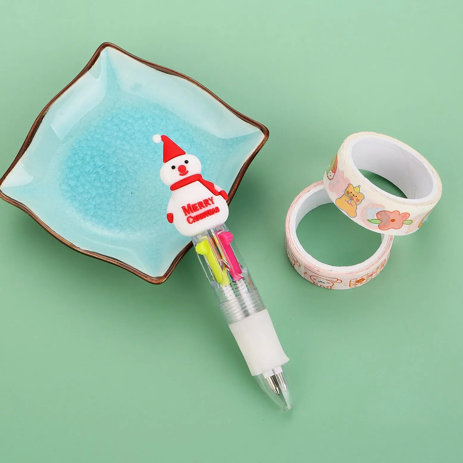 Christmas mini four-colour press-type ballpoint pen showing festive designs, 11cm long.