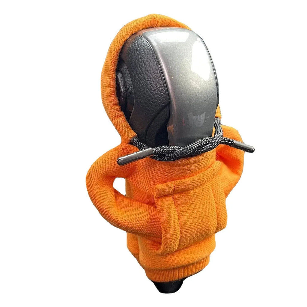Cloth gear shift knob hoodie cover in assorted colours, shown next to a car gear stick.